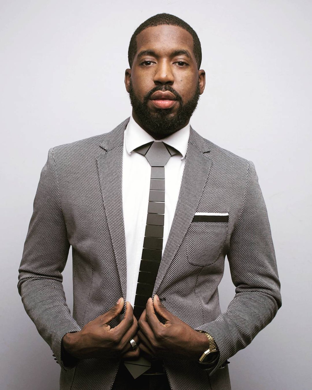 Portrait of DJ Roco in a grey suit