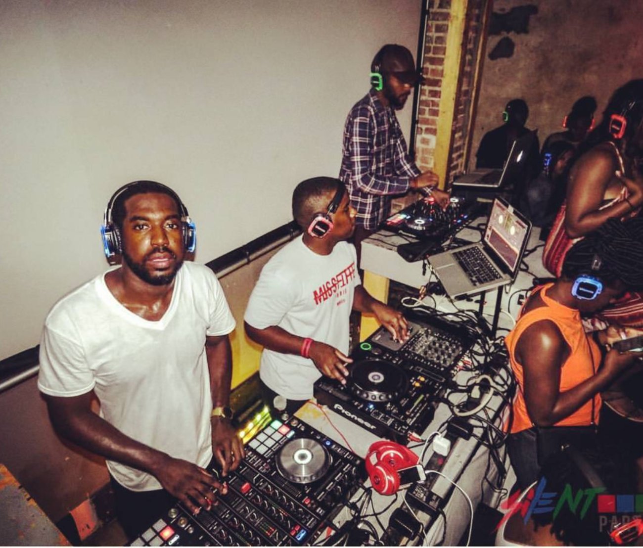 DJ Roco and the crowd in glowing headphones at Silent Party ATL